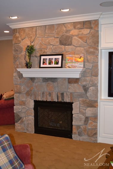 These two similar stone fireplaces are situated on a corner, facing the main space, providing the atmosphere of a fireplace without taking up a large footprint in their respective rooms. 