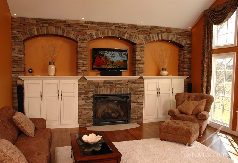 In this living room, the fireplace is just one component to a feature wall containing several design solutions.