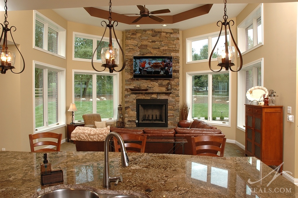 Taking advantage of this room's ceiling height, this fireplace shares the spotlight with the back-yard view.