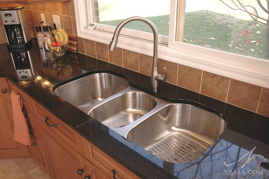 A stainless steel triple bowl kitchen sink in this West Chester kitchen.