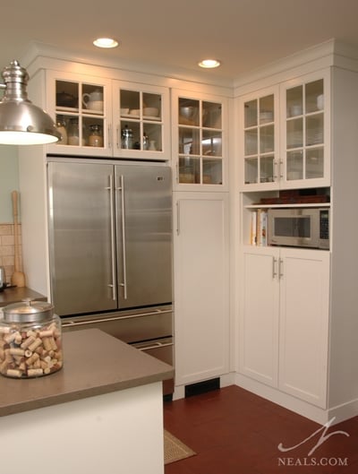 Display cabinets in this kitchen hold extra serveware.