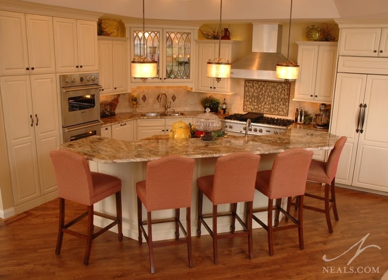 A horseshoe-shaped island provides seating for five outside the working zone in this kitchen.