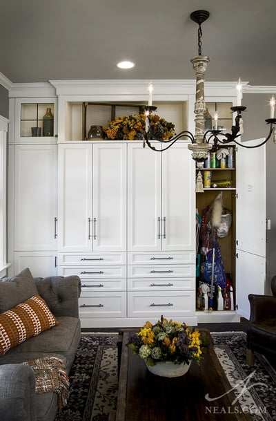 A seating area at the end of this kitchen is home to a broom closet.