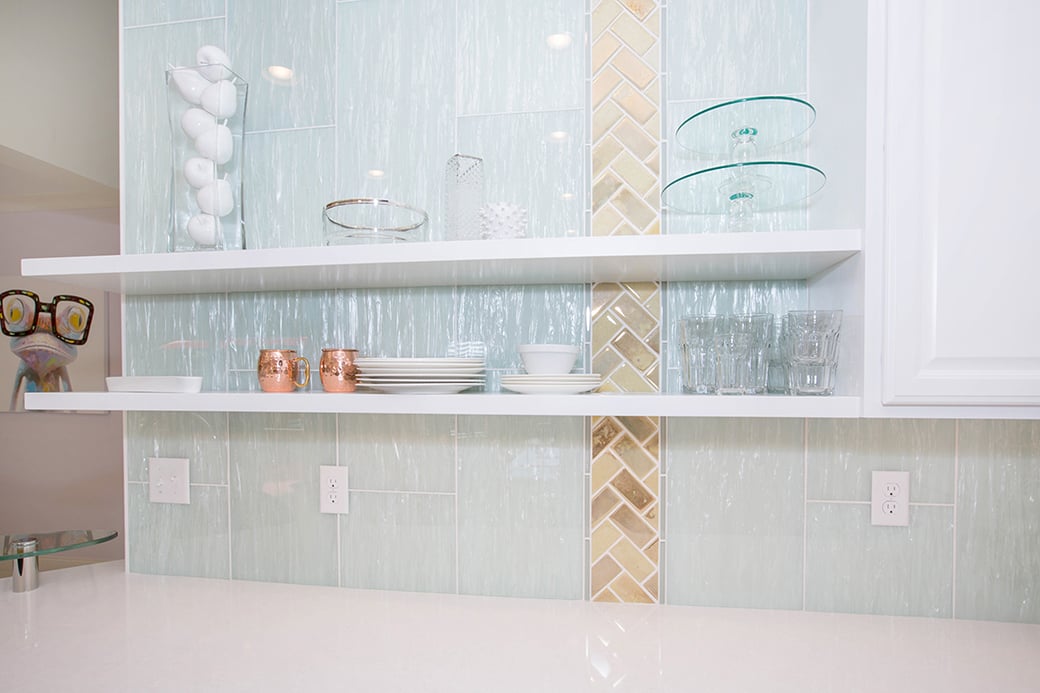 Open floating shelves in this Cleves kitchen keep dishware within easy reach.