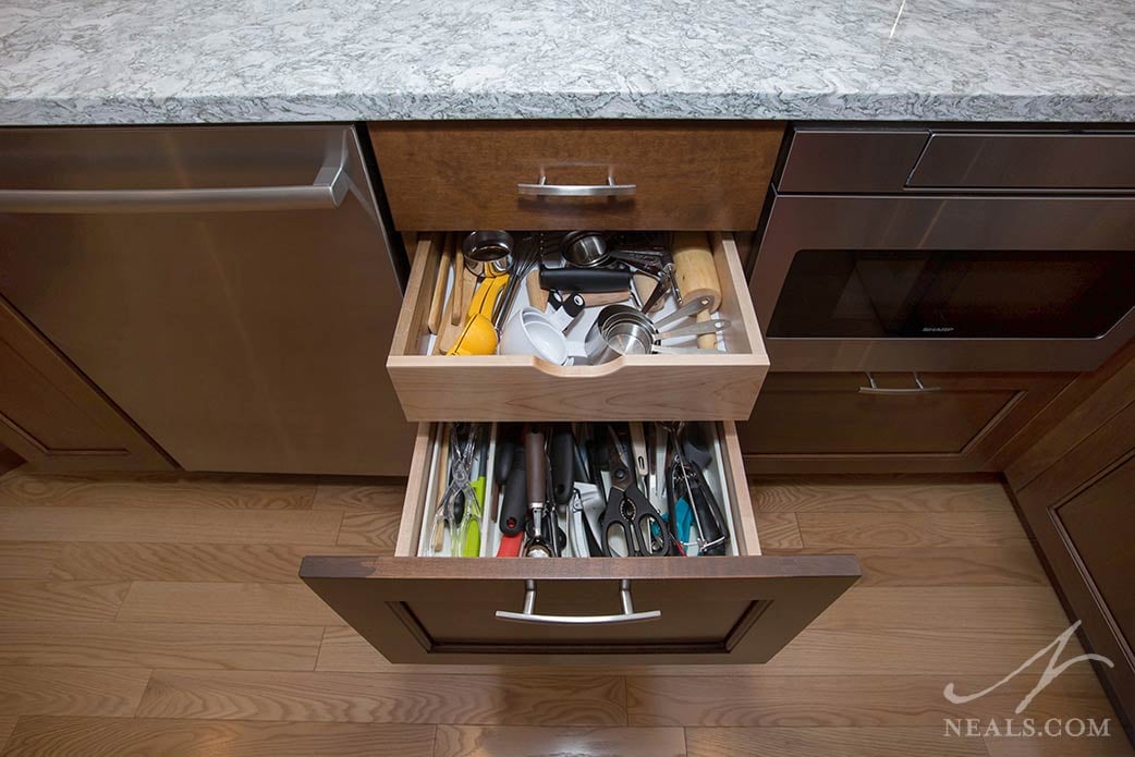 A drawer tray slides back to reveal even more storage capacity in this Montgomery kitchen.