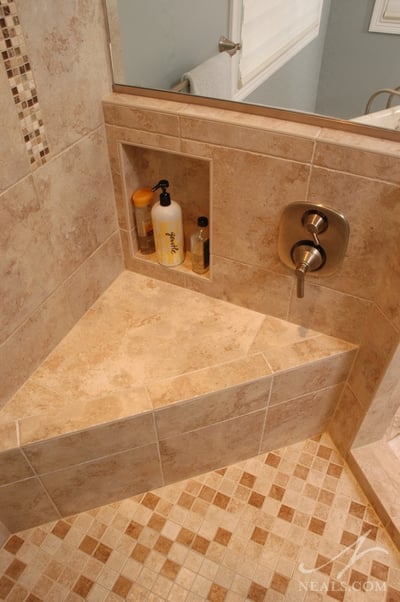 Shower controls and a niche are hidden on the back side of a knee wall.