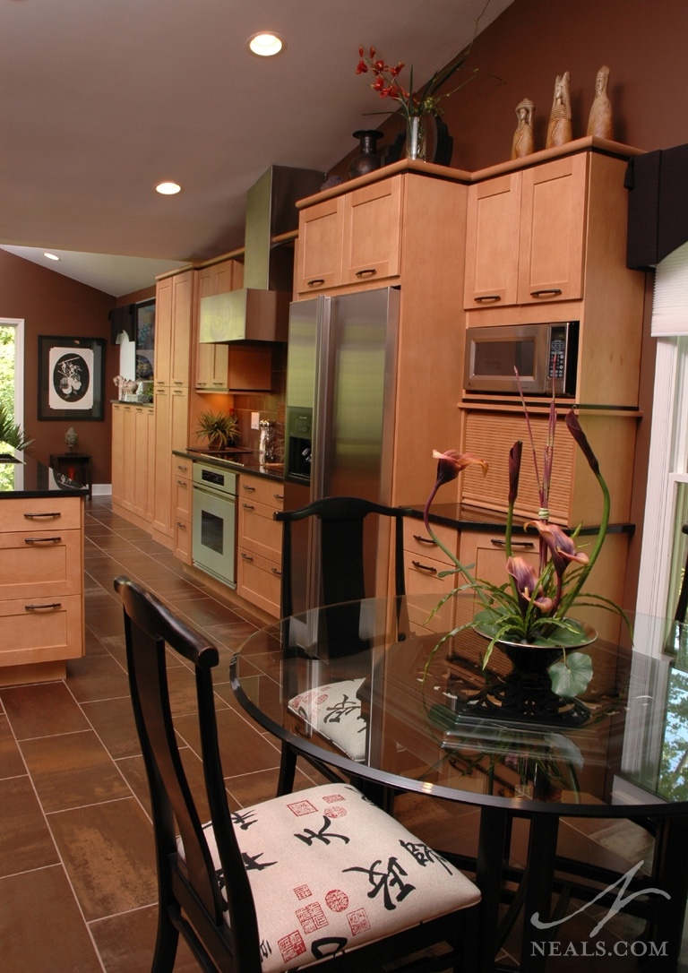 Touches of black in this Asian-inspired Montgomery kitchen, including black counters and trim, add contrast to all the neutral browns. Black items in the decor carry the theme even further.