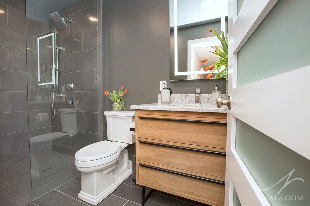 Integrated lighting in the vanity mirror in this Anderson Township bath.